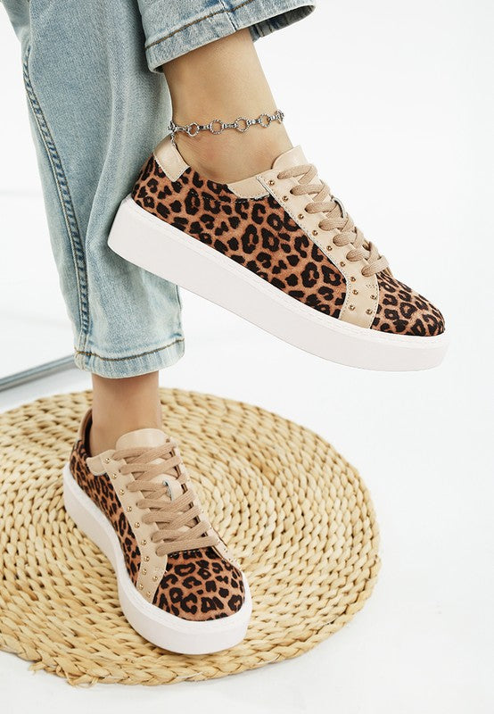 person wearing leopard print fashion lace up sneakers with jeans