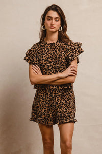 Woman wearing Leopard Print Waffle Texture Layered Ruffle Sleeve Top and Shorts Set-This leopard print set features a leopard print waffle texture top with layered ruffle sleeves, paired with matching shorts for a coordinated and stylish look. 
