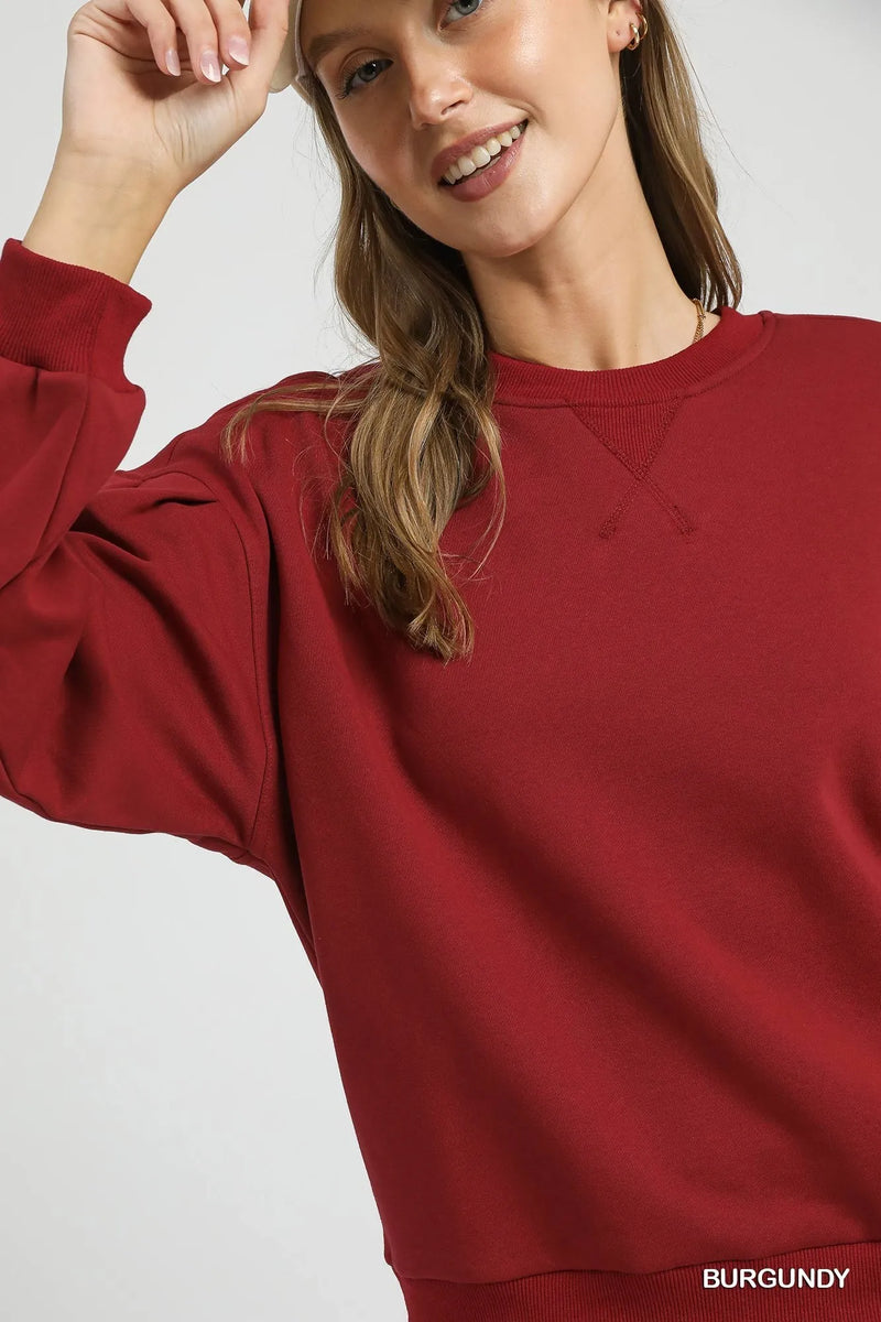 Burgundy Sweatshirt with Pleated Detail-Cozy meets chic in this burgundy pleated sweatshirt. A fall-ready round neck pullover with soft sleeve details, perfect for layering or lounging. Sizes XS–L.-Reef Love Boutique