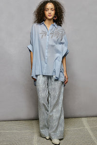 Sky blue 100% cotton POL button-down shirt with intricate leaf embroidery, voluminous sleeves, and high-low hem.