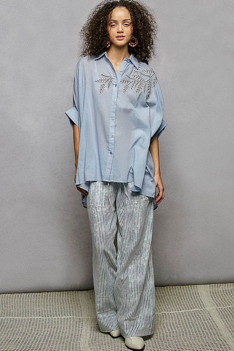 Sky blue 100% cotton POL button-down shirt with intricate leaf embroidery, voluminous sleeves, and high-low hem.