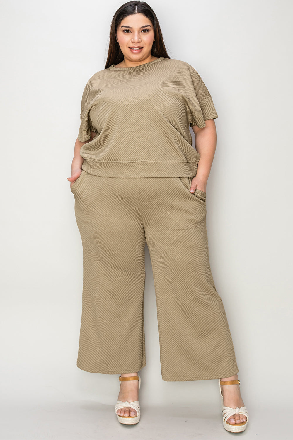 Textured, stretchy, and comfy. This two piece cropped pant with short sleeve top is a great travel set to stay comfortable in the car or plane. Available in a variety of colors and extended sizes.