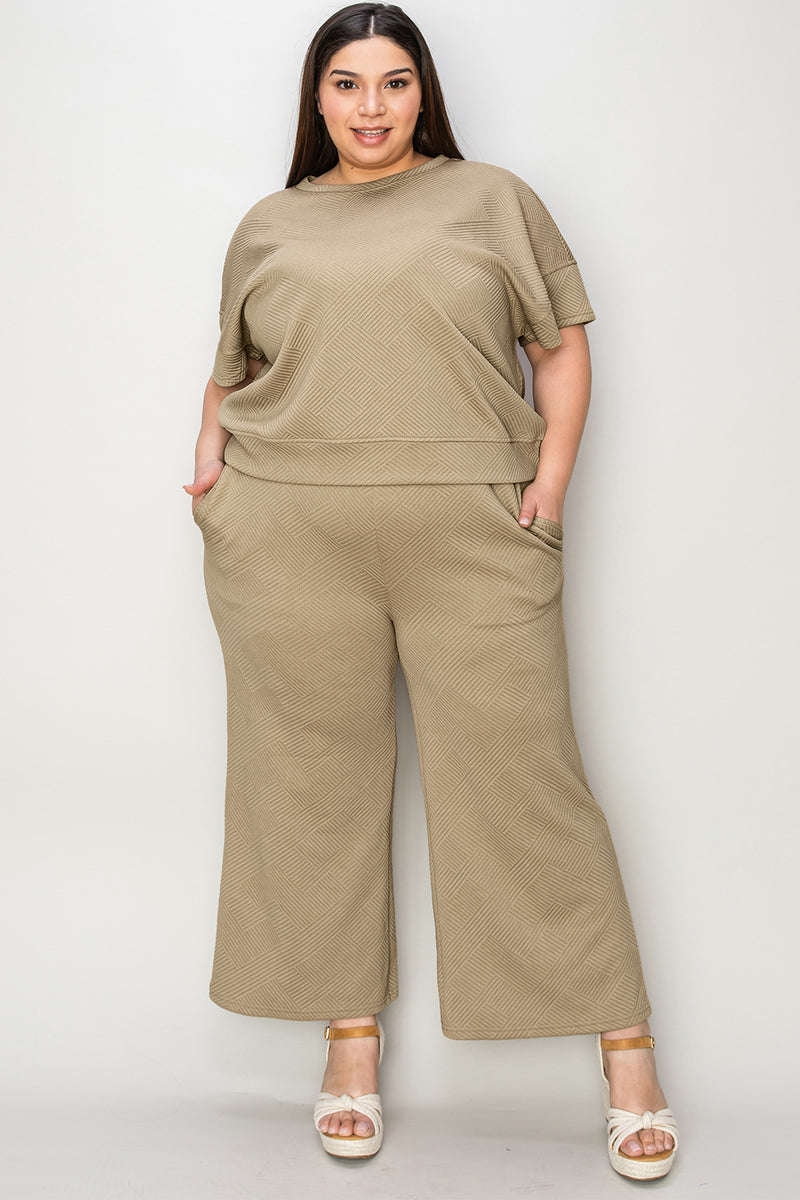 Textured, stretchy, and comfy. This two piece cropped pant with short sleeve top is a great travel set to stay comfortable in the car or plane. Available in a variety of colors and extended sizes.