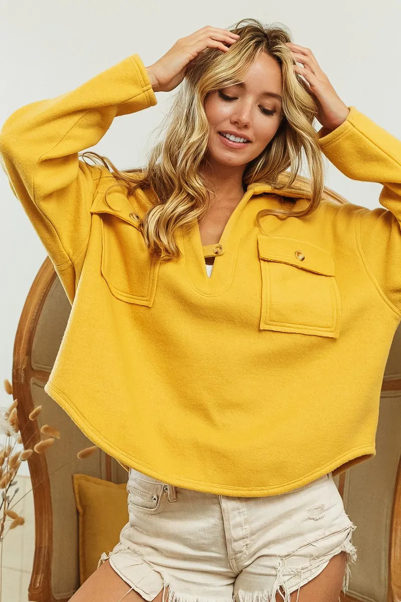 Woman wearing Honey Mustard Fleece Collared Sweatshirt-Fleece collared sweatshirt with flap pockets and button details. Cozy, stylish, and perfect for layering all season long, your new cozy fall favorite.