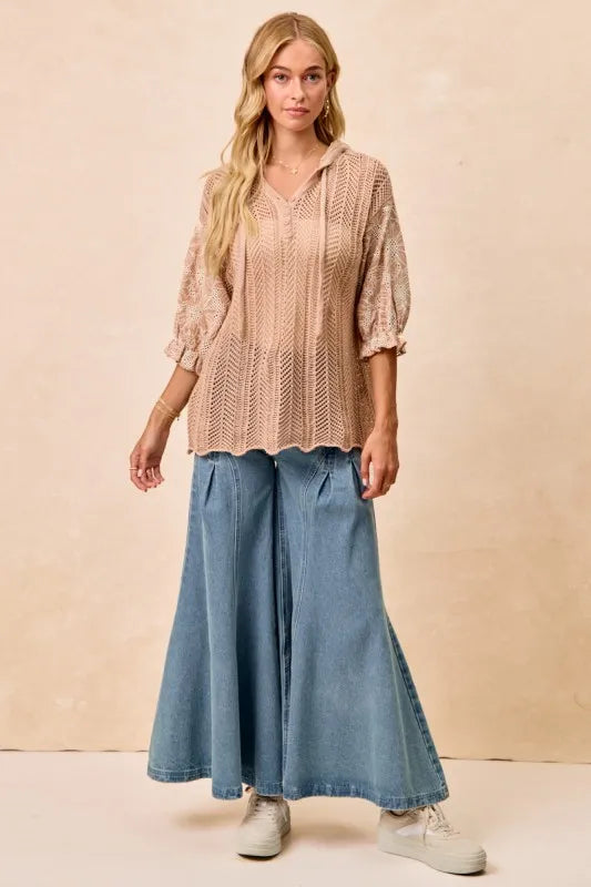 Woman wearing Jacquard Flower Puff Sleeve Hooded Knit Top-This jacquard flower puff sleeve hooded knit top combines intricate floral patterns with a touch of volume in the sleeves for a stylish look, elevate your knitwear.