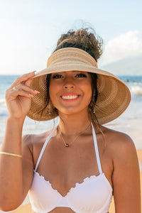 person smiling on beach wearing Marled Stripe Roll up Bow Visor-Reef Love