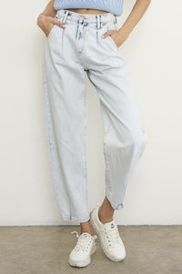 Woman wearing Balloon Slouch Jeans-Balloon Slouch Jeans in light wash denim with high-rise fit, pleated front, and relaxed ankle-length silhouette. 100% cotton for that true vintage feel.
