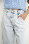 Woman wearing Balloon Slouch Jeans-Balloon Slouch Jeans in light wash denim with high-rise fit, pleated front, and relaxed ankle-length silhouette. 100% cotton for that true vintage feel.