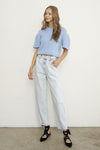 Woman wearing Balloon Slouch Jeans-Balloon Slouch Jeans in light wash denim with high-rise fit, pleated front, and relaxed ankle-length silhouette. 100% cotton for that true vintage feel.