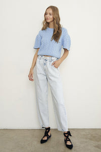 Woman wearing Balloon Slouch Jeans-Balloon Slouch Jeans in light wash denim with high-rise fit, pleated front, and relaxed ankle-length silhouette. 100% cotton for that true vintage feel.