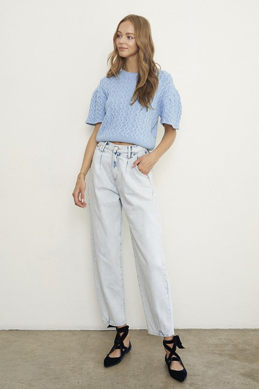 Woman wearing Balloon Slouch Jeans-Balloon Slouch Jeans in light wash denim with high-rise fit, pleated front, and relaxed ankle-length silhouette. 100% cotton for that true vintage feel.