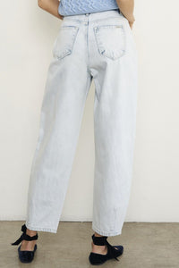 Woman wearing Balloon Slouch Jeans-Balloon Slouch Jeans in light wash denim with high-rise fit, pleated front, and relaxed ankle-length silhouette. 100% cotton for that true vintage feel.