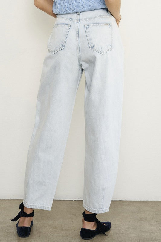Woman wearing Balloon Slouch Jeans-Balloon Slouch Jeans in light wash denim with high-rise fit, pleated front, and relaxed ankle-length silhouette. 100% cotton for that true vintage feel.