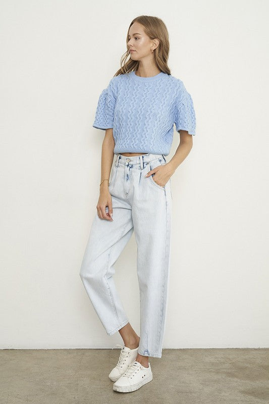 Woman wearing Balloon Slouch Jeans-Balloon Slouch Jeans in light wash denim with high-rise fit, pleated front, and relaxed ankle-length silhouette. 100% cotton for that true vintage feel.
