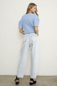 Woman wearing Balloon Slouch Jeans-Balloon Slouch Jeans in light wash denim with high-rise fit, pleated front, and relaxed ankle-length silhouette. 100% cotton for that true vintage feel.