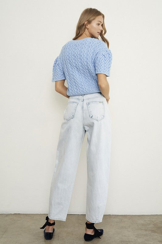Woman wearing Balloon Slouch Jeans-Balloon Slouch Jeans in light wash denim with high-rise fit, pleated front, and relaxed ankle-length silhouette. 100% cotton for that true vintage feel.