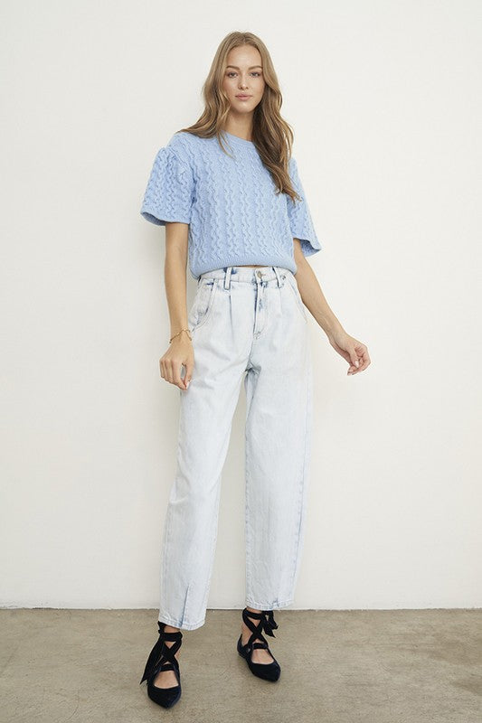 Woman wearing Balloon Slouch Jeans-Balloon Slouch Jeans in light wash denim with high-rise fit, pleated front, and relaxed ankle-length silhouette. 100% cotton for that true vintage feel.