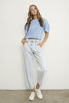 Woman wearing Balloon Slouch Jeans-Balloon Slouch Jeans in light wash denim with high-rise fit, pleated front, and relaxed ankle-length silhouette. 100% cotton for that true vintage feel.