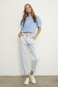 Woman wearing Balloon Slouch Jeans-Balloon Slouch Jeans in light wash denim with high-rise fit, pleated front, and relaxed ankle-length silhouette. 100% cotton for that true vintage feel.