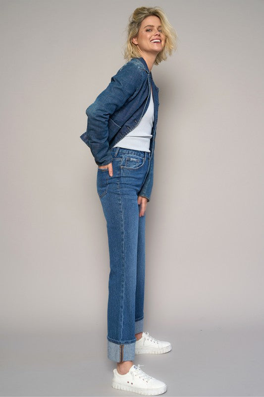 Woman wearing High Rise Cuff Cropped Bootcut Jeans-Flattering women's high-rise cuffed crop boot jeans in dark wash denim. Stretchy, cropped, and stylish—perfect for casual-chic looks.