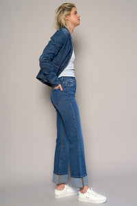Woman wearing High Rise Cuff Cropped Bootcut Jeans-Flattering women's high-rise cuffed crop boot jeans in dark wash denim. Stretchy, cropped, and stylish—perfect for casual-chic looks.