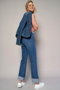 Woman wearing High Rise Cuff Cropped Bootcut Jeans-Flattering women's high-rise cuffed crop boot jeans in dark wash denim. Stretchy, cropped, and stylish—perfect for casual-chic looks.
