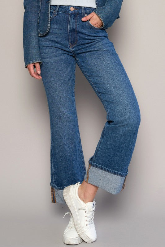 Woman wearing High Rise Cuff Cropped Bootcut Jeans-Flattering women's high-rise cuffed crop boot jeans in dark wash denim. Stretchy, cropped, and stylish—perfect for casual-chic looks.