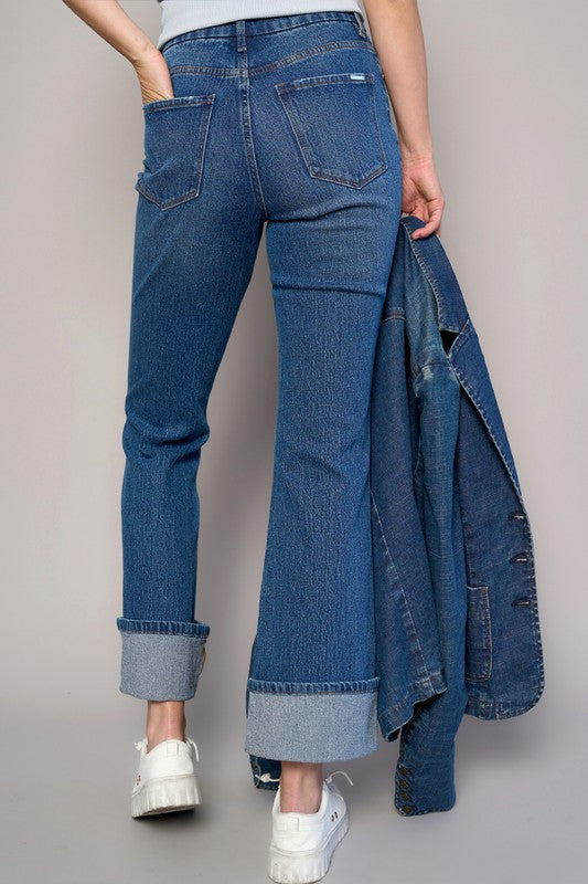 Woman wearing High Rise Cuff Cropped Bootcut Jeans-Flattering women's high-rise cuffed crop boot jeans in dark wash denim. Stretchy, cropped, and stylish—perfect for casual-chic looks.