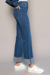 Woman wearing High Rise Cuff Cropped Bootcut Jeans-Flattering women's high-rise cuffed crop boot jeans in dark wash denim. Stretchy, cropped, and stylish—perfect for casual-chic looks.