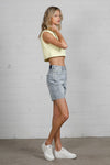 Shop High Rise Mid-Length Bermuda Shorts-These High Rise Bermuda Shorts in medium wash denim feature a raw hem, flattering mid-thigh length, and 100% cotton construction—perfect for warm-weather style.-Reef Love Boho-Chic Boutique