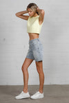 Shop High Rise Mid-Length Bermuda Shorts-These High Rise Bermuda Shorts in medium wash denim feature a raw hem, flattering mid-thigh length, and 100% cotton construction—perfect for warm-weather style.-Reef Love Boho-Chic Boutique