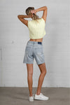 Shop High Rise Mid-Length Bermuda Shorts-These High Rise Bermuda Shorts in medium wash denim feature a raw hem, flattering mid-thigh length, and 100% cotton construction—perfect for warm-weather style.-Reef Love Boho-Chic Boutique
