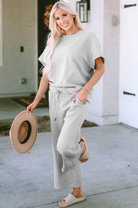Textured, stretchy, and comfy. This two piece cropped pant with short sleeve top is a great travel set to stay comfortable in the car or plane. Available in a variety of colors and extended sizes.