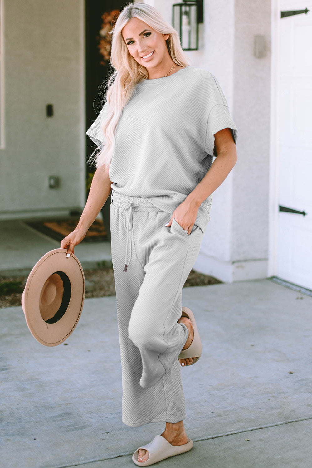 Textured, stretchy, and comfy. This two piece cropped pant with short sleeve top is a great travel set to stay comfortable in the car or plane. Available in a variety of colors and extended sizes.