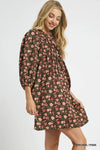 Woman wearing Fall Floral Tie-Neck Babydoll Dress-Fall floral tie-neck babydoll dress is a charming choice for any occasion. The tie-neck detail adds a touch of elegance to the sweet babydoll silhouette.