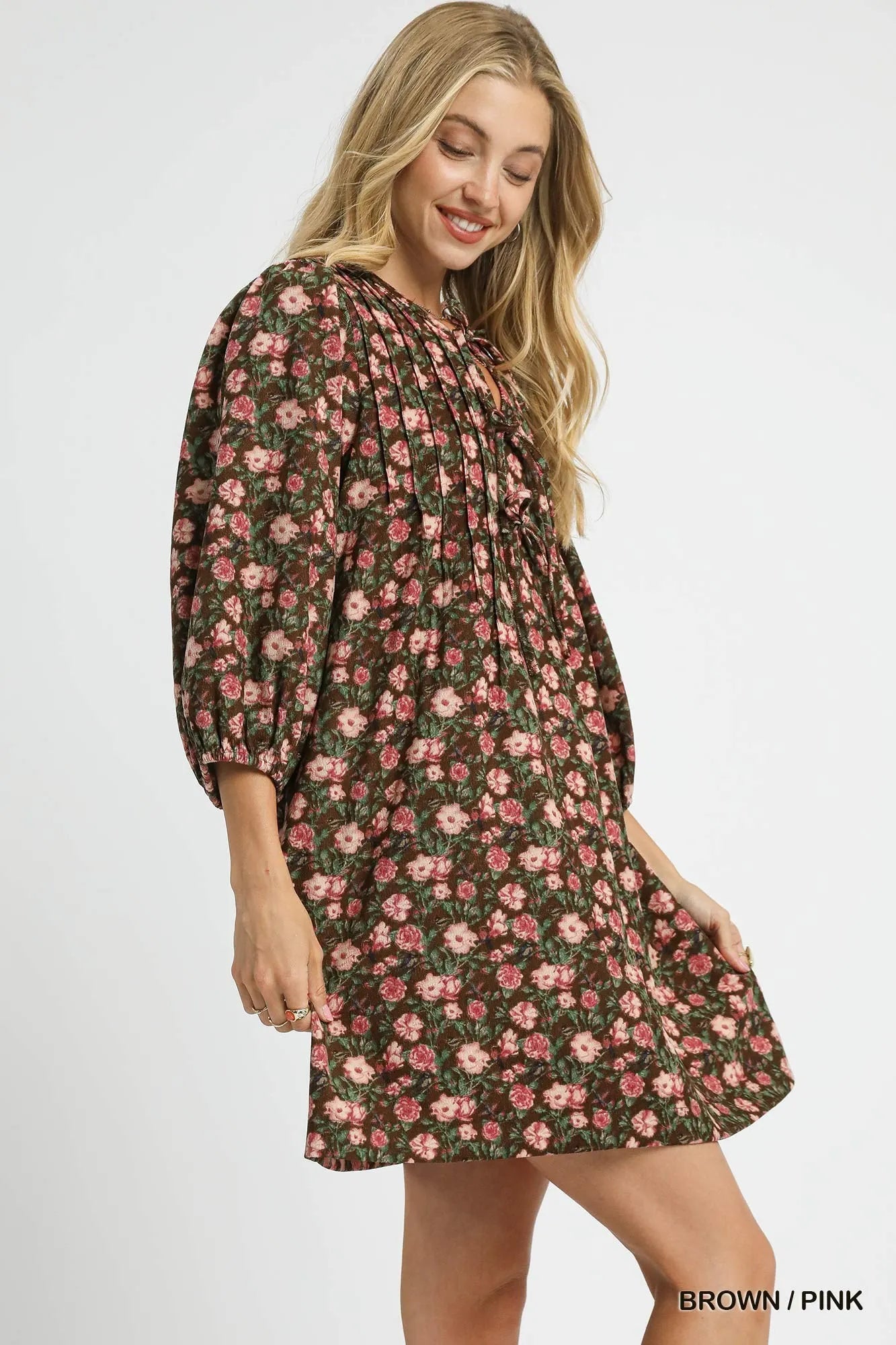 Woman wearing Fall Floral Tie-Neck Babydoll Dress-Fall floral tie-neck babydoll dress is a charming choice for any occasion. The tie-neck detail adds a touch of elegance to the sweet babydoll silhouette.