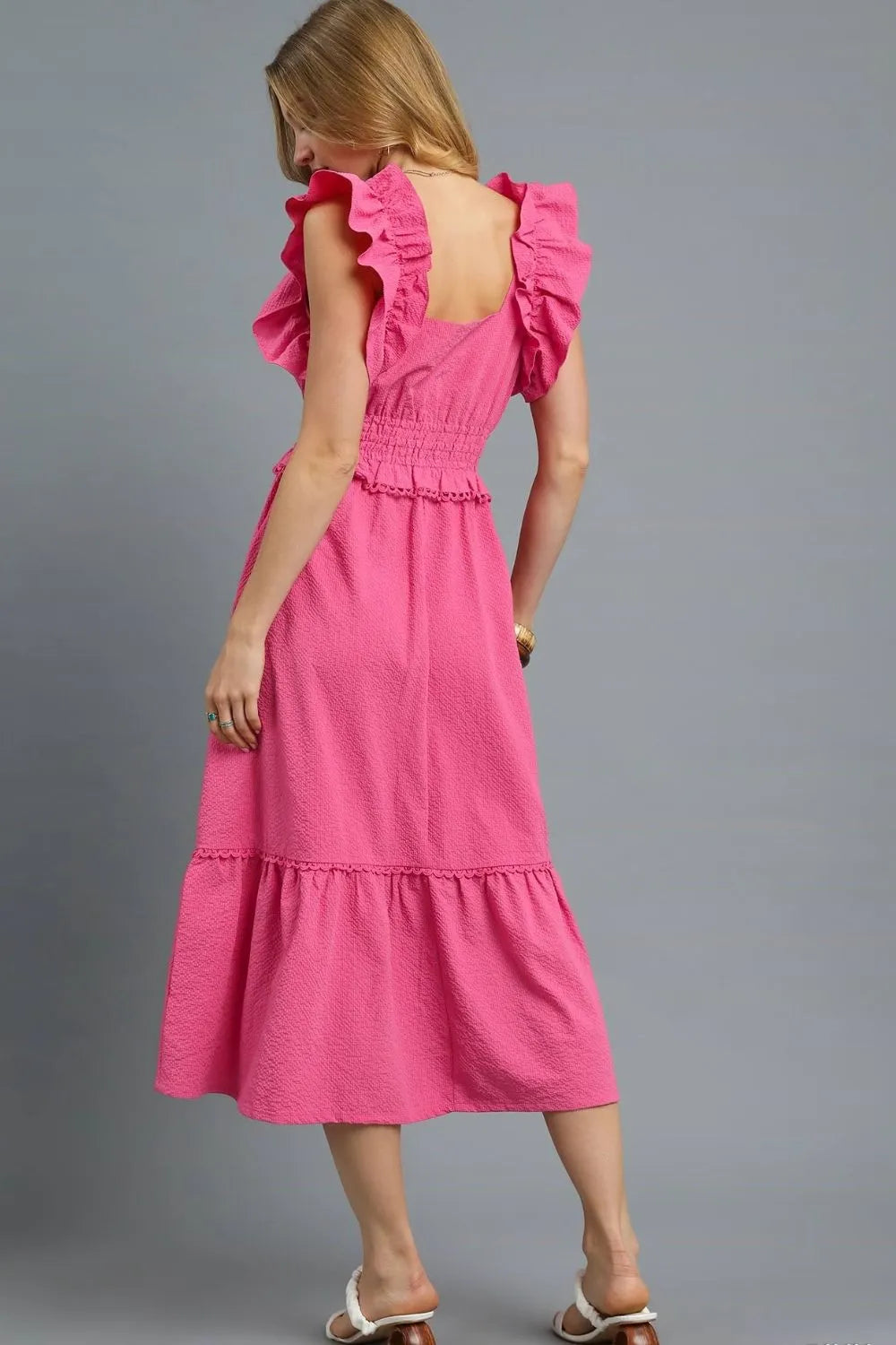 Woman wearing Hot Pink V-Neck Ruffled Cap Sleeve Midi Dress-Stunning midi dress with eye-catching ruffle shoulders and a flattering waist that accentuates your silhouette. Grest for brunch dates and garden parties.