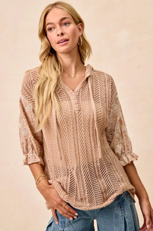 Woman wearing Jacquard Flower Puff Sleeve Hooded Knit Top-This jacquard flower puff sleeve hooded knit top combines intricate floral patterns with a touch of volume in the sleeves for a stylish look, elevate your knitwear.