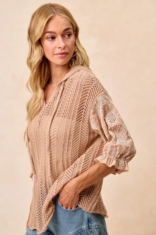 Woman wearing Jacquard Flower Puff Sleeve Hooded Knit Top-This jacquard flower puff sleeve hooded knit top combines intricate floral patterns with a touch of volume in the sleeves for a stylish look, elevate your knitwear.