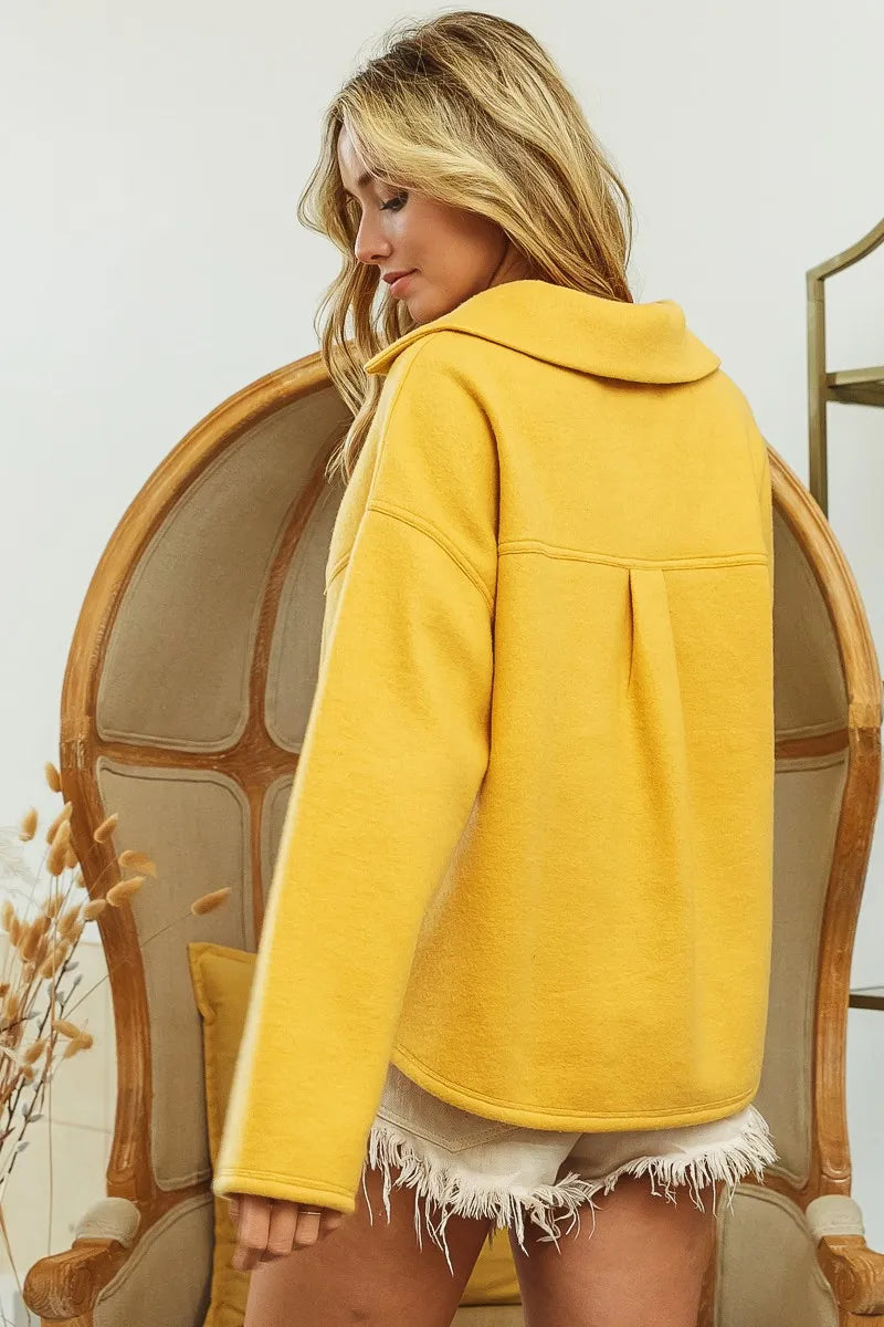 Woman wearing Honey Mustard Fleece Collared Sweatshirt-Fleece collared sweatshirt with flap pockets and button details. Cozy, stylish, and perfect for layering all season long, your new cozy fall favorite.