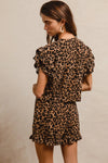 Woman wearing Leopard Print Waffle Texture Layered Ruffle Sleeve Top and Shorts Set-This leopard print set features a leopard print waffle texture top with layered ruffle sleeves, paired with matching shorts for a coordinated and stylish look. 