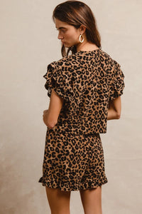 Woman wearing Leopard Print Waffle Texture Layered Ruffle Sleeve Top and Shorts Set-This leopard print set features a leopard print waffle texture top with layered ruffle sleeves, paired with matching shorts for a coordinated and stylish look. 