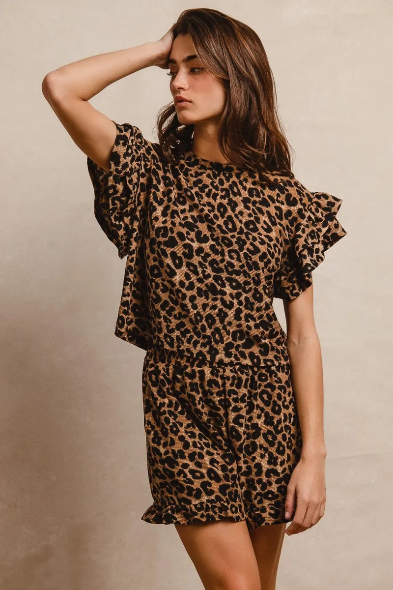Woman wearing Leopard Print Waffle Texture Layered Ruffle Sleeve Top and Shorts Set-This leopard print set features a leopard print waffle texture top with layered ruffle sleeves, paired with matching shorts for a coordinated and stylish look. 