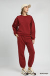 Burgundy Sweatshirt with Pleated Detail-Cozy meets chic in this burgundy pleated sweatshirt. A fall-ready round neck pullover with soft sleeve details, perfect for layering or lounging. Sizes XS–L.-Reef Love Boutique