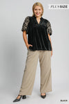Woman wearing Velvet Embroidered Sleeve Blouse-This velvet embroidered sleeve blouse combines luxe velvet with embroidery for a sophisticated and stylish look. Perfect for adding a touch of glamour to your outfit.