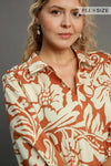 Woman wearing Floral Tiered Midi Shirt Dress-Flowy floral tiered midi shirt dress with 3/4 sleeves in rust + beige print. Boho-chic style in standard & plus sizes for casual or dressy days.