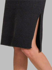 Woman wearing Turtle Neck Long Sleeve Midi Sweater Dress, Black-Turtle Neck Long Sleeve Midi Sweater Dress, a cozy and chic addition to your fall and winter wardrobe. This dress is perfect for casual and dressier occasions.