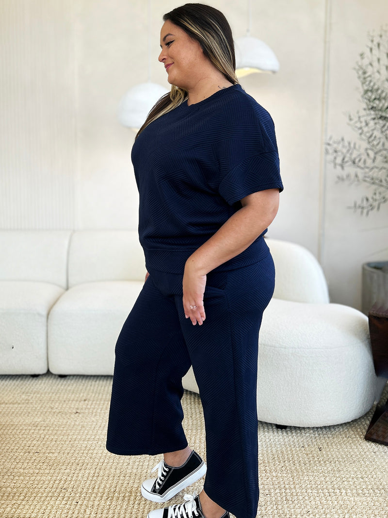 Textured, stretchy, and comfy. This two piece cropped pant with short sleeve top is a great travel set to stay comfortable in the car or plane. Available in a variety of colors and extended sizes.