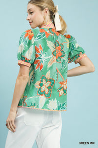 Fashionable green mixed abstract print puff sleeve blouse with a V-neckline, made from 100% cotton.