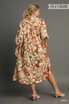 Woman wearing Floral Tiered Midi Shirt Dress-Flowy floral tiered midi shirt dress with 3/4 sleeves in rust + beige print. Boho-chic style in standard & plus sizes for casual or dressy days.